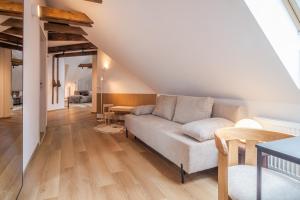 a living room with a couch and a table at Apartmány Ski Telgárt - Telgárt Resort in Telgárt +68 photos