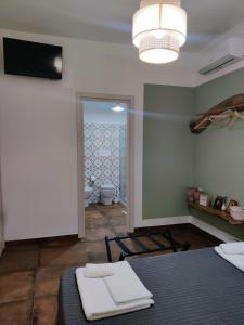 a room with a bed and a bathroom with a mirror at Palazzo ReSilente- B&B dell'Infopoint in Castelnuovo Cilento