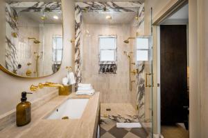 a bathroom with a tub and a shower with a sink at Polo House and Bungalows in Santa Ynez +217 photos