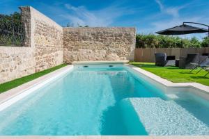 a swimming pool in the backyard of a house at Domaine de La Bourse in Vérigny