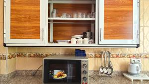 a microwave in a kitchen with a plate of food at Indigo House in Chefchaouen +18 photos