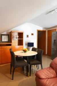 a kitchen and dining room with a table and chairs at Casas de São Roque in Vila do Conde