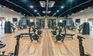 a gym with rows of treadmills and machines at Akumal Bay Beach & Spa Resort in Akumal