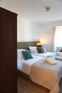 two beds sitting next to each other in a bedroom at Casas de São Roque in Vila do Conde