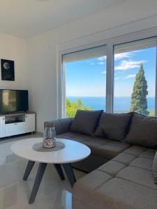 a living room with a couch and a table at Vila Marbela in Seoca