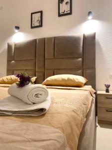 a large bed with a leather headboard in a bedroom at Vila Marbela in Seoca +34 photos