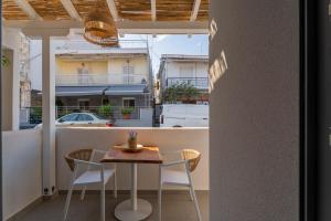 a table and chairs on a balcony with a view at IOSIF hideaway in Neos Marmaras