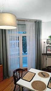 a dining room with a table and a window at Chrobry Square - Art Apartament in Gorzów Wielkopolski