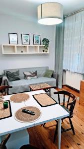 a living room with a table and a couch at Chrobry Square - Art Apartament in Gorzów Wielkopolski