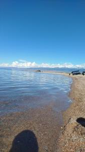 a shadow of a person standing on a beach at Тайыз Кол in Tossor