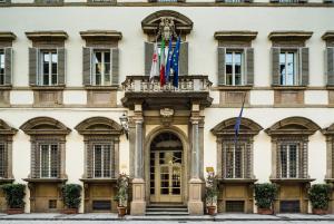 a building with two flags in front of it at Palazzo Firenze by Baglioni Hotels & Resorts in Florence
