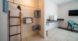 a bathroom with a sink and a chair in a room at Luna Azul Bacalar in Bacalar