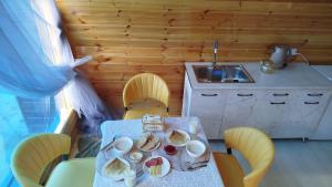 a kitchen with a table with plates of food on it at Тайыз Кол in Tossor
