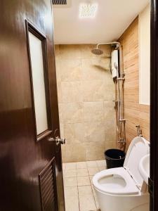a bathroom with a toilet and a sink at Haku Haven in Baguio +4 photos
