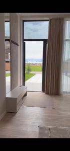 a large room with a large glass door with a large window at Вип Вилла у берега in Chon-Sary-Oy +5 photos