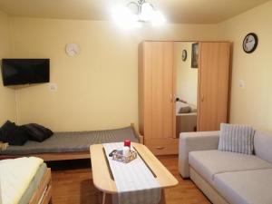 a living room with a couch and a table at Sky&Lake Apartments Gdańsk in Gdańsk