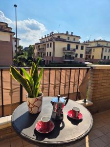 a table with two cups and saucers on a balcony at Castello Vignola in Vignola