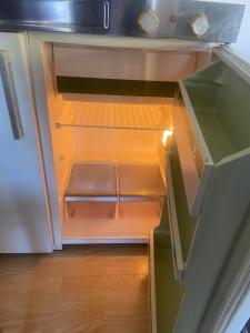 an empty drawer in a kitchen with the door open at Röda huset in Åhus