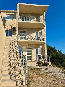 a building with a staircase leading up to it at Vila Marbela in Seoca
