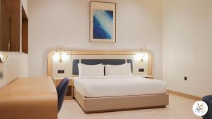a hotel room with a bed and a table at V Beach in Jeddah +15 photos