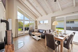 a living room with a table and a couch at Luxuswellnesshaus Seepferdchen in Bliesdorf