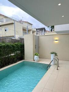 a swimming pool in front of a building at Antilia home 1 in Abidjan
