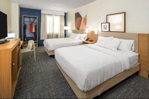 a hotel room with two beds and a desk at Spark by Hilton Clifton in Clifton