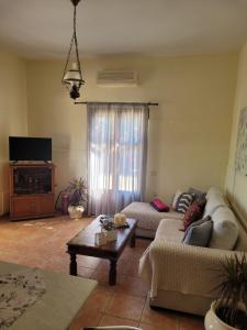 a living room with a couch and a coffee table at kouremenos beach house East in Angathiás
