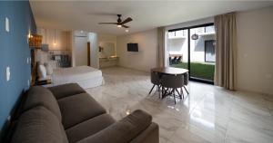a living room with a couch and a bed at Luna Azul Bacalar in Bacalar