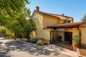 a house with a gate and trees at Studio Apartman Blue Sky in Senj