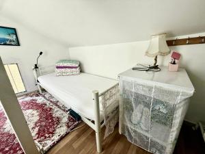 a room with a bed and a lamp on a table at paris kiffe in Villejuif