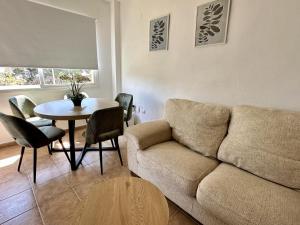 a living room with a couch and a table at Los Pescadores Playa Sol in Novo Sancti Petri