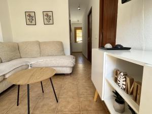 a living room with a couch and a table at Los Pescadores Playa Sol in Novo Sancti Petri