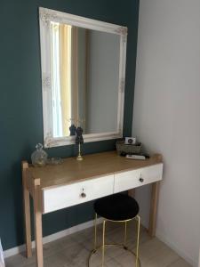 a dressing table with a mirror and a stool at Hotel Διεθνές in Zacharo +82 photos