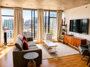 a living room with a couch and large windows at Historic Downtown Escape in Vancouver