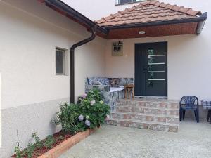 a pergola on the side of a house at Kuća - Šekovići in Šekovići