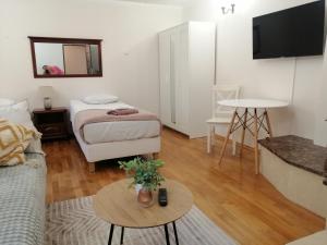 a room with a bed and a couch and a table at Sky&Lake Apartments Gdańsk in Gdańsk