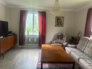 a living room with a couch and a tv at Retro hus in Kosta