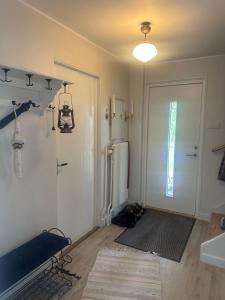 a living room with a refrigerator and a door at Retro hus in Kosta