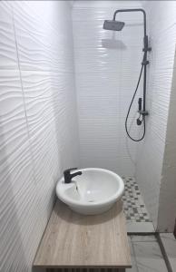 a white bathroom with a sink and a shower at MRH Self Check- In Express Homestay in Modimolle