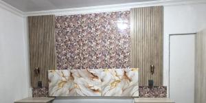 a bedroom with a wall with a floral wallpaper at MRH Self Check- In Express Homestay in Modimolle +1 photo
