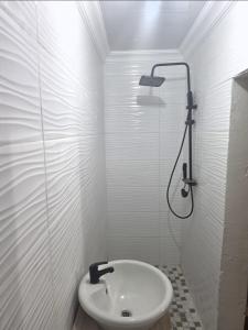 a white bathroom with a shower and a sink at MRH Self Check- In Express Homestay in Modimolle