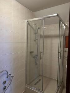 a shower with a glass door in a bathroom at Restoran Orahovica Konjic - sobe in Konjic +7 photos