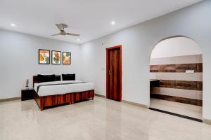a bedroom with a bed and an open door at Hotel O rudra paradise in New Delhi