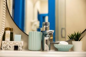 a bathroom counter with a bottle of soap and a mirror at Cherhana Resort in Crisan +72 photos