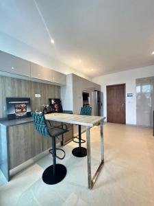 a kitchen with a wooden table and two chairs at Antilia home 1 in Abidjan