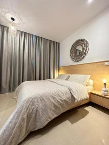 a bedroom with a large bed and a mirror at Antilia home 1 in Abidjan