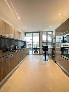 a large kitchen with a table in the middle at Antilia home 1 in Abidjan