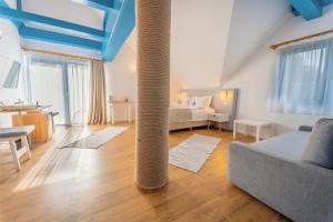 a large room with a bed and a column in it at Cherhana Resort in Crisan
