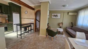a living room with a couch and a table at Villa Guzi in Orihuela Costa